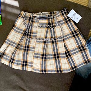 mini skirt featuring an allover plaid pattern, and high-polish wallet chains.